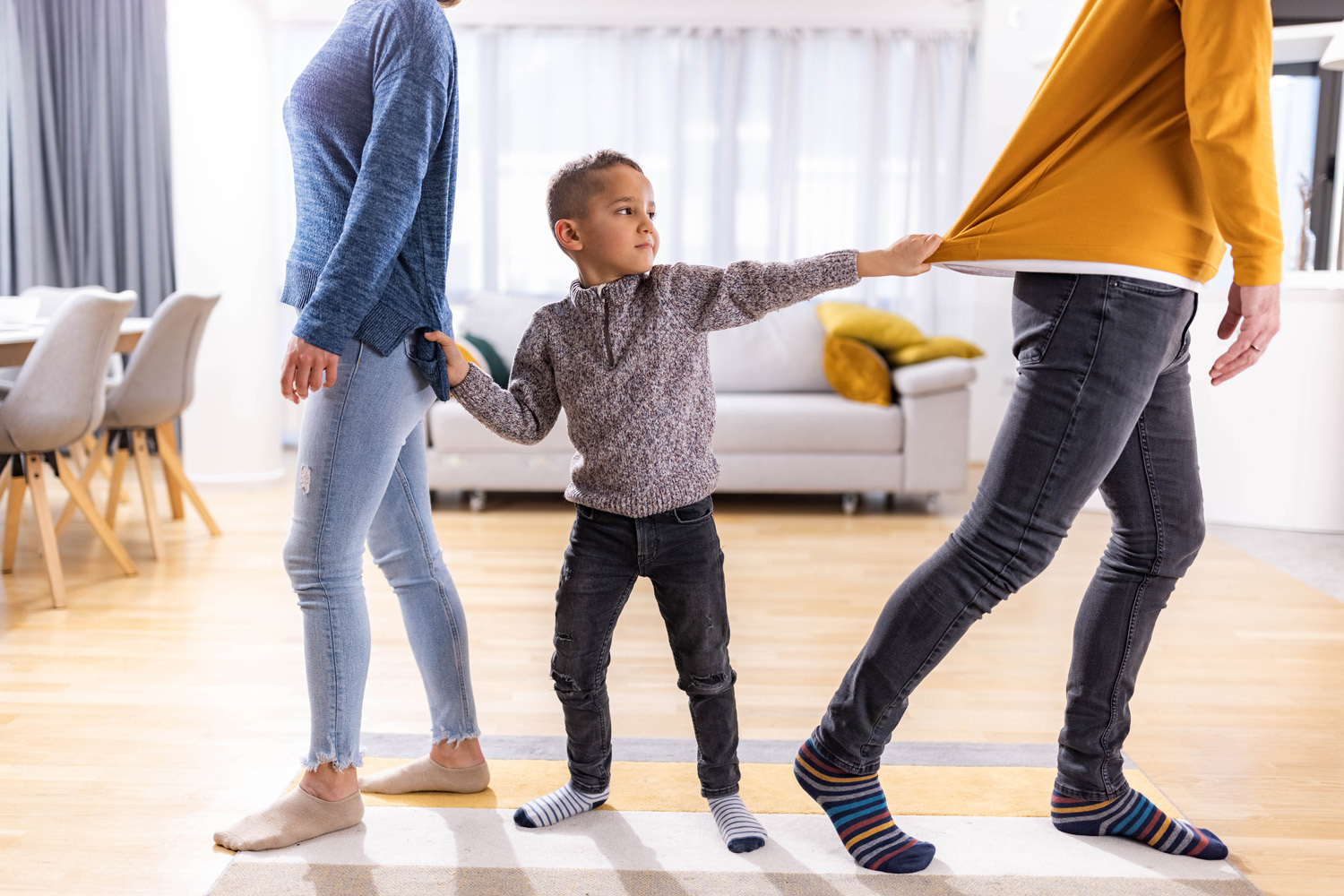 Boy pulling parents together