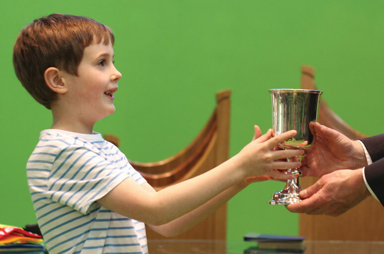 Boy receiving communion wine cropped