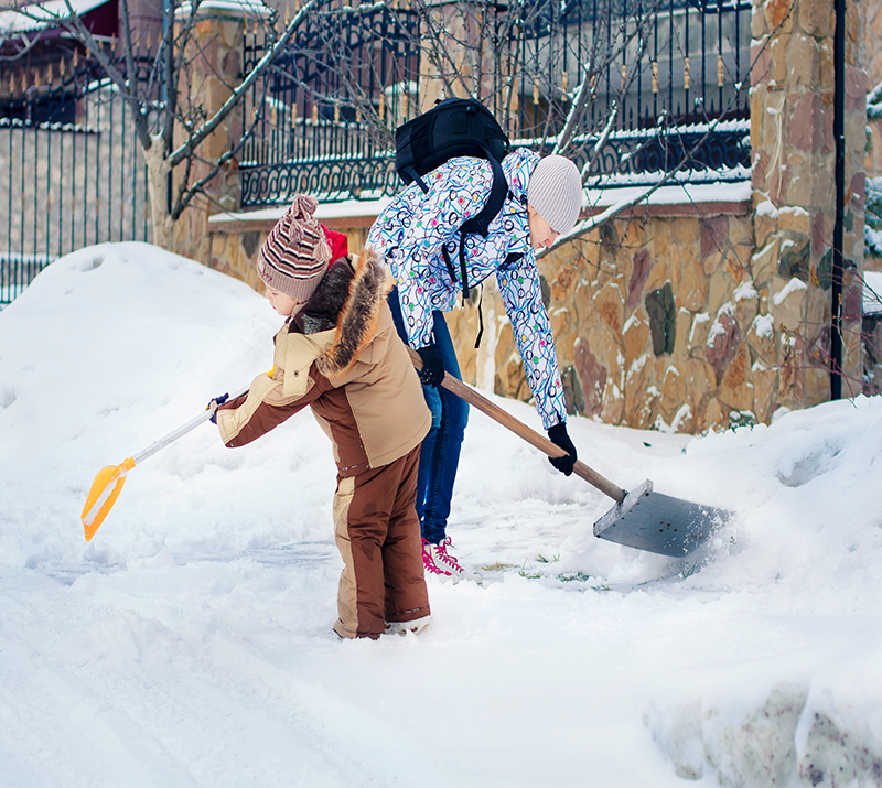Family clearing snow