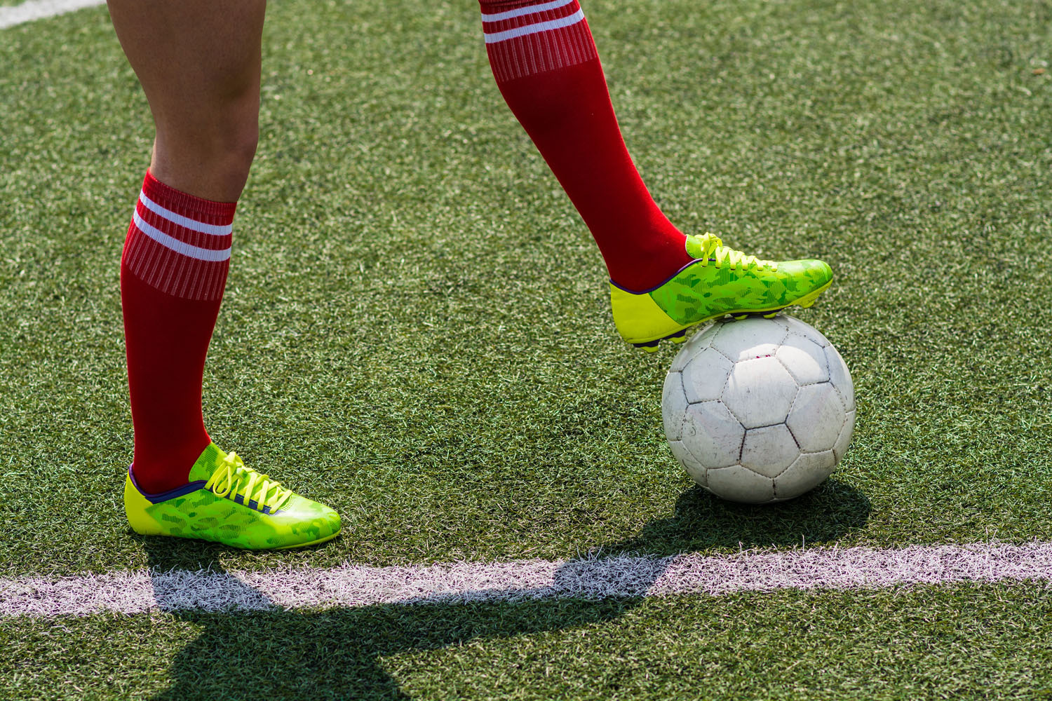 Football players legs with ball
