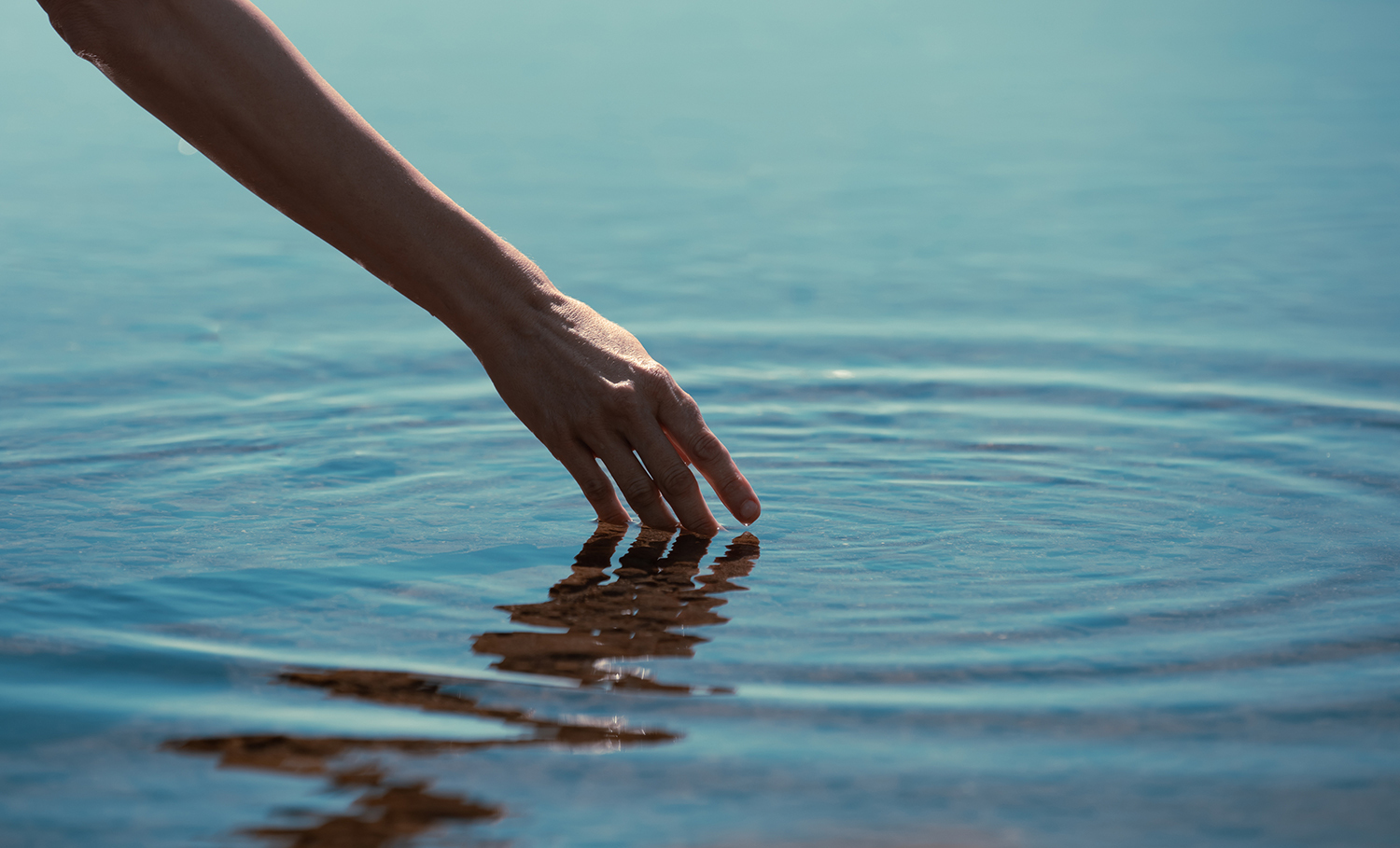 Hand trailing in water