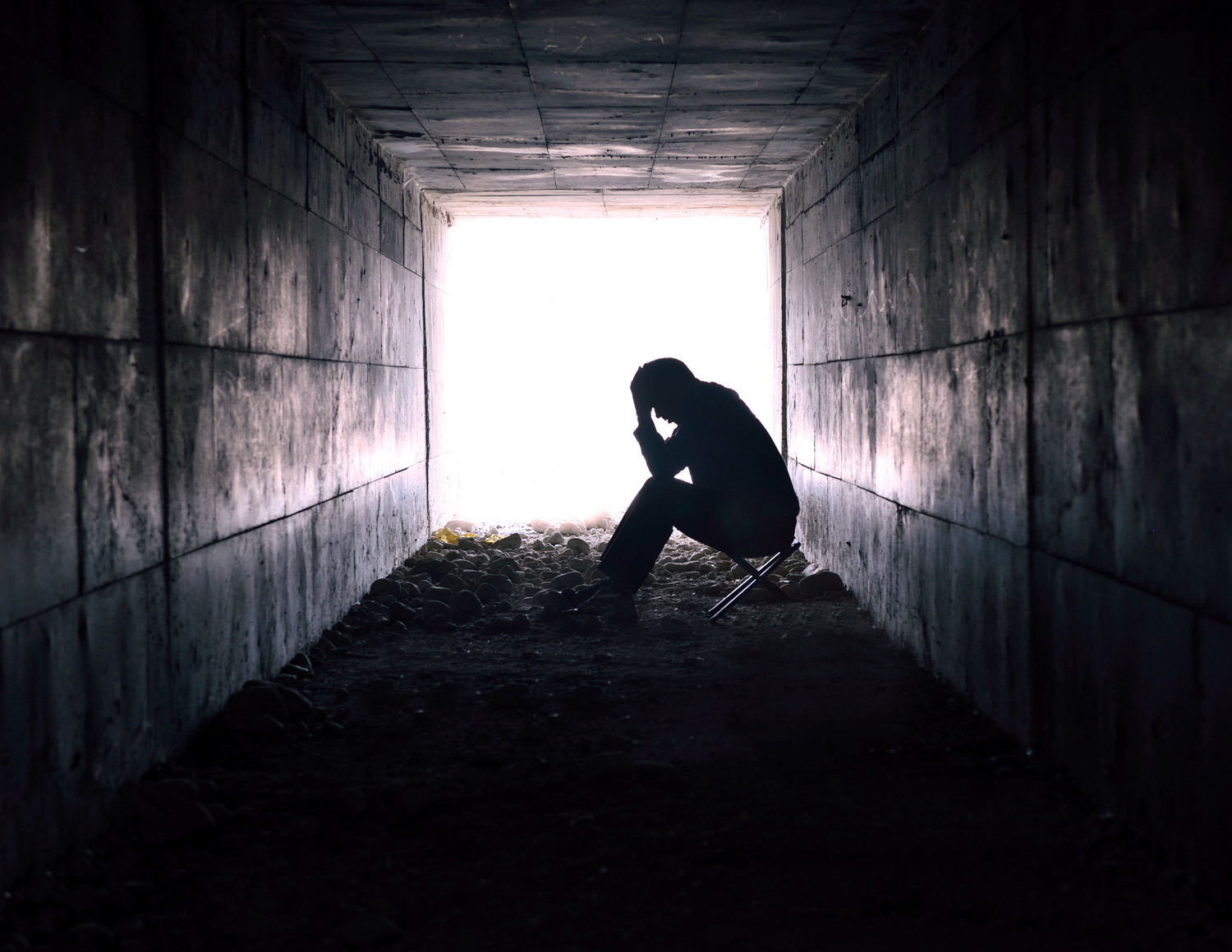 Man sitting in tunnel