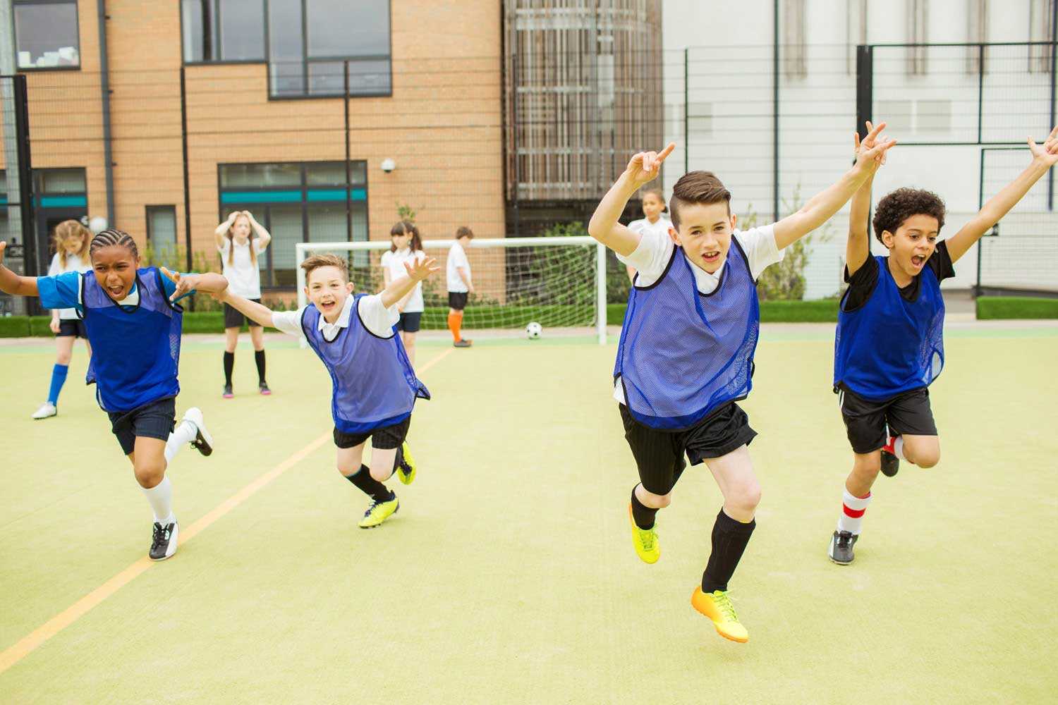 School boys after scoring goal 1500px