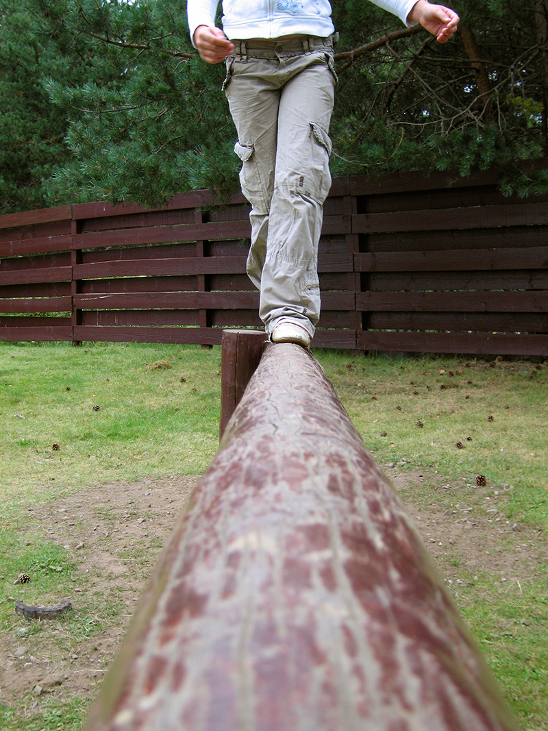 Teenager balancing on beam