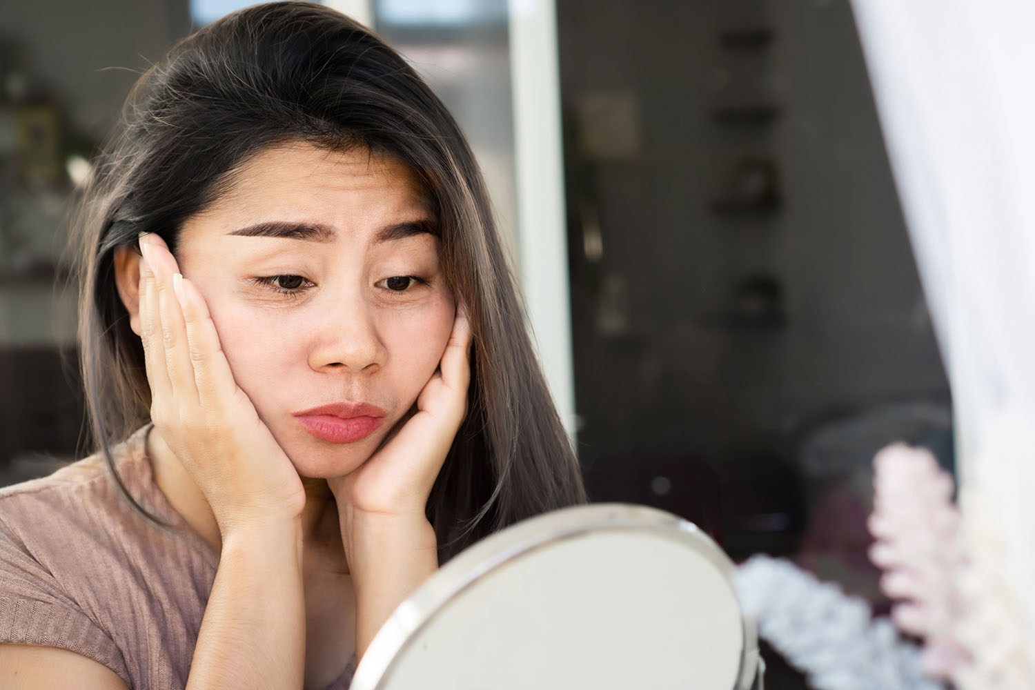Woman looking in mirror