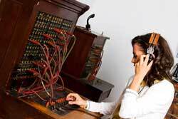 Woman operating vintage switchboard 250px