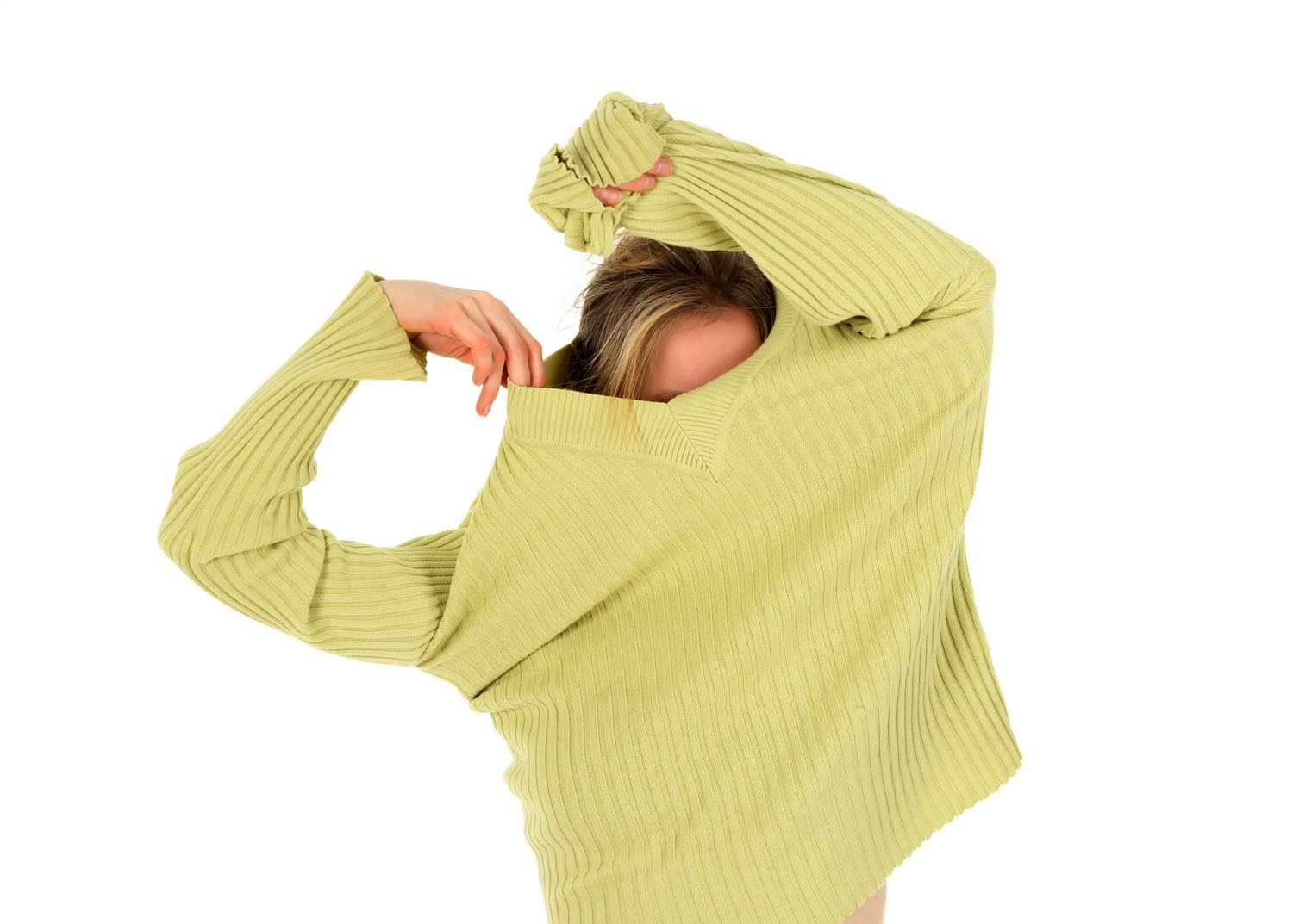Woman removing green sweater