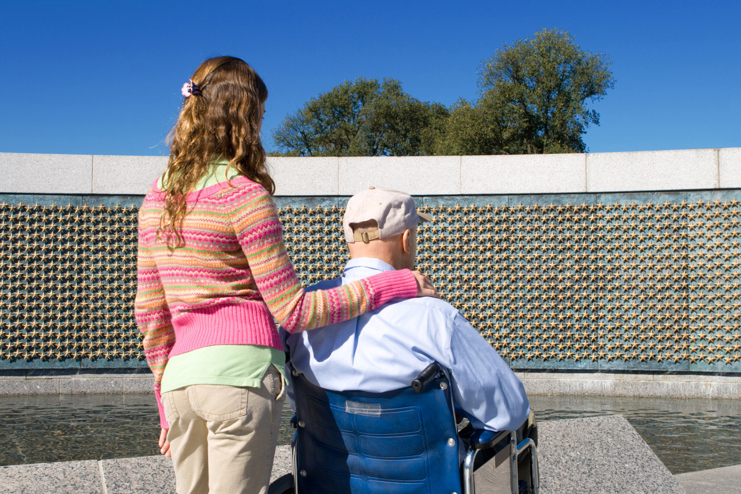 Young woman with elderly man in wheelchair